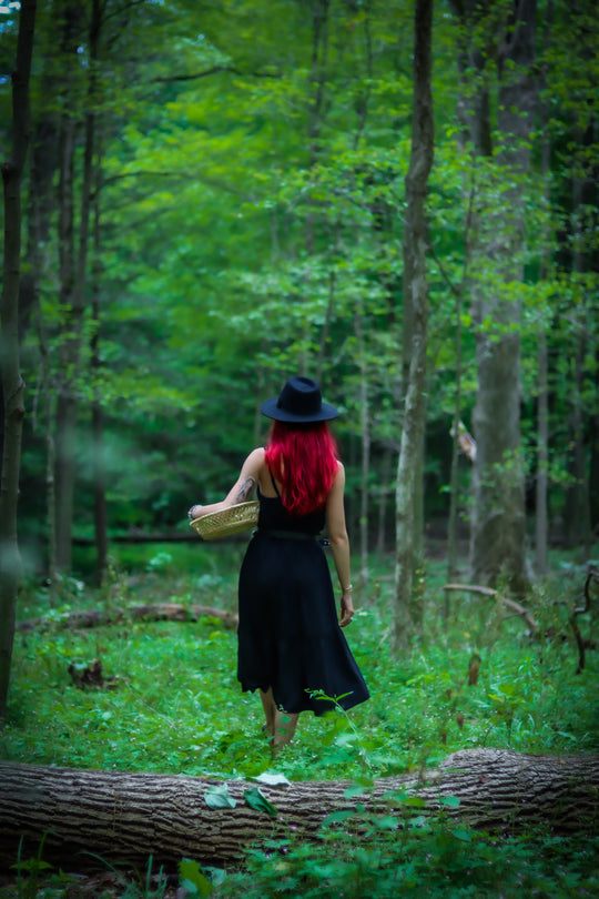 Jessica Rose Durante, licensed Clinical Herbalist, walking through the forest